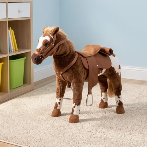 Brown plush horse toy with saddle and bridle, side view