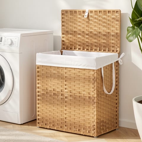 Rattan laundry basket with lid and compartments, filled with folded clothes