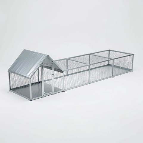 Large metal chicken coop with green netting and chickens inside, surrounded by trees and flowers.