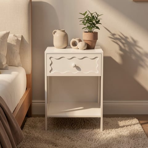 White nightstand with wavy drawer and open shelf in a bedroom