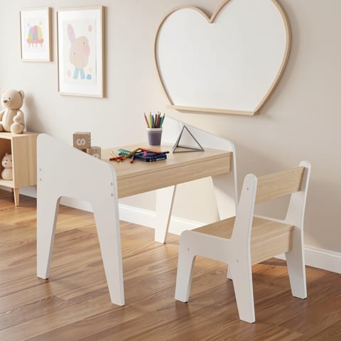 A child's desk and chair set in a room with a drawing on the wall