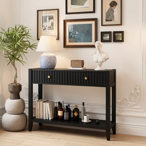 Black console table with drawers and shelf in a living room