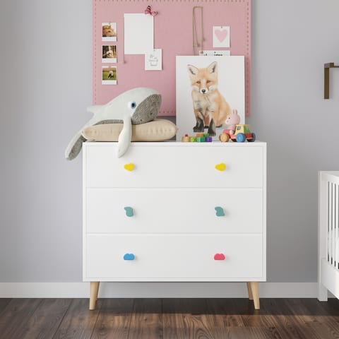 White 3-drawer dresser with colorful knobs in a child's room