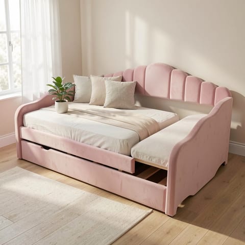 Pink velvet daybed with trundle pulled out in a cozy room