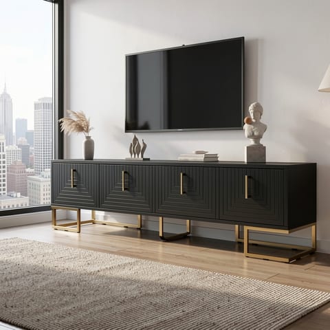 Modern black TV stand with gold handles and metal legs in a living room