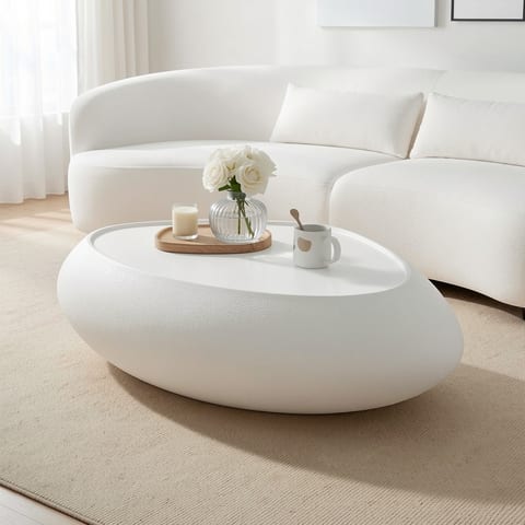 Oval coffee table with faux matte rocks texture in a living room