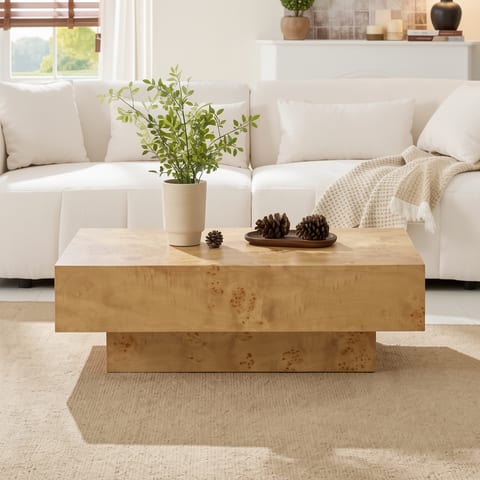 Burl wood veneer coffee table in a living room with a white couch