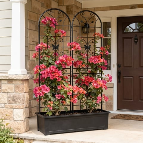 Black metal garden trellis with pink flowers on a house porch