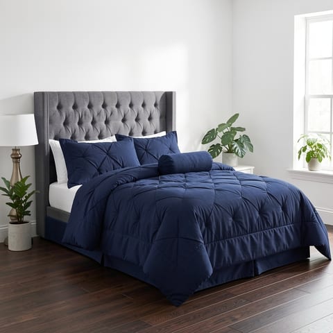 Navy blue 7-piece comforter set on a bed