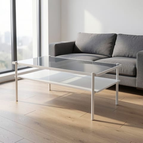 Gray tempered glass top coffee table with white legs on a woven rug