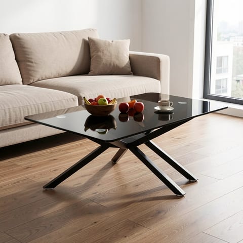 Black glass coffee table with black metal legs on a white background
