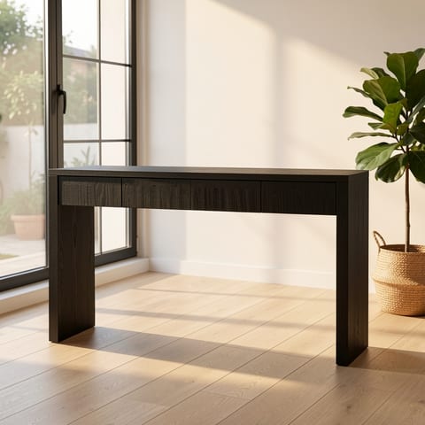 Black console table with 4 drawers against a white wall