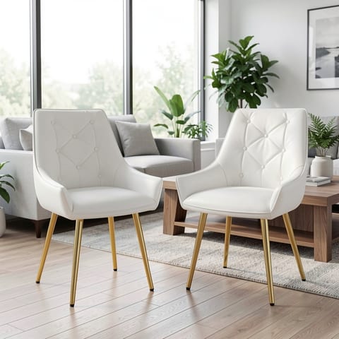 White accent chair with gold legs and tufted backrest in a modern living room