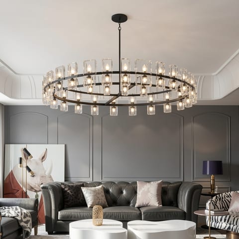 A black chandelier with clear glass shades and bulbs lit.