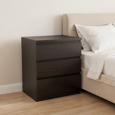 black 3-drawer nightstand beside a bed