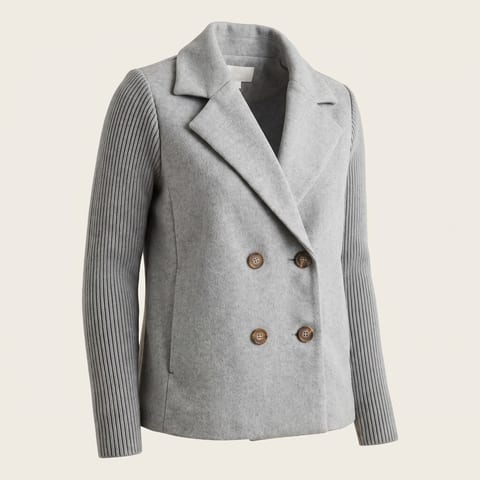 Light gray double breasted jacket with ribbed knit sleeves worn with jeans