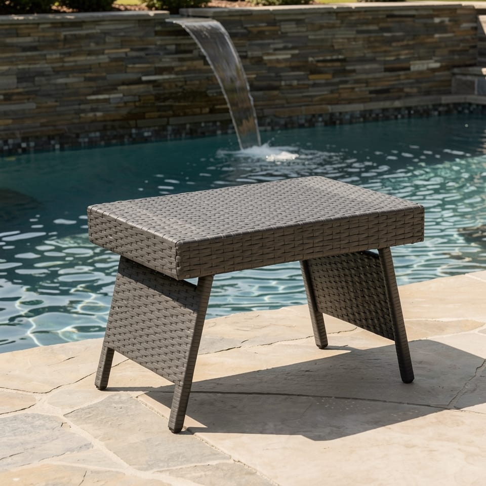 Wicker snack table by a pool with a waterfall feature